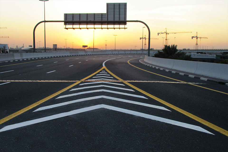 White Dotted and Yellow Solid Lines Machine Marking at Sun Rise, Dubai