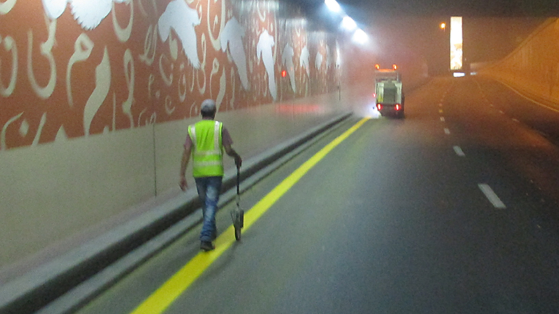 Machine Marking Solid Yellow Line, at Night, Dubai